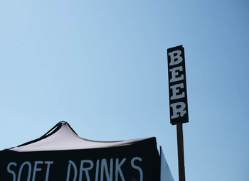 Low angle view of information sign against clear sky