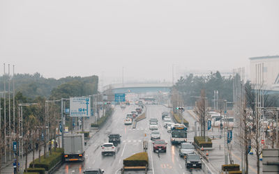 Cars on street against sky during monsoon