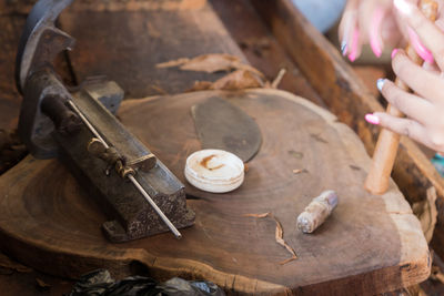 Close-up of woman working on wood at workshop