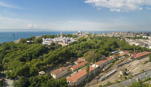 High angle view of buildings and sea against sky