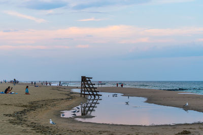 Scenic view of beach against sky during sunset