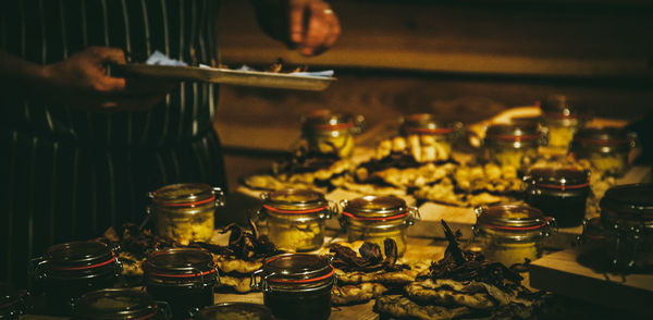 Midsection of man eating food by table