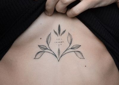 Midsection of woman with tattoo