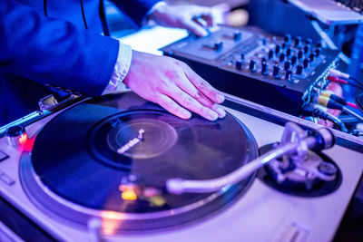 Close-up of person playing records
