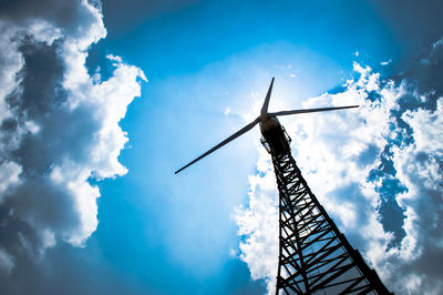 Low angle view of windmill against blue sky