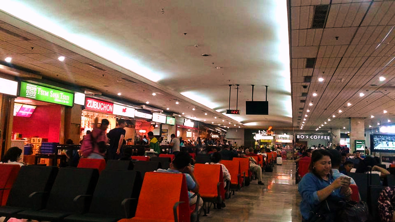 Waiting for our flight to Bacolod at Mactan Cebu International Airport Airport Life Business Mactan Cebu International Airport MactanInternationalAirport Passenger Tourist Waiting Area Airport Airport Departure Area Airport Stalls Airport Waiting Airportphotography Airports Built Structure Chairs Crowd Domestic Flight Group Of People Indoors  Large Group Of People People Real People Sitting Stalls Travel