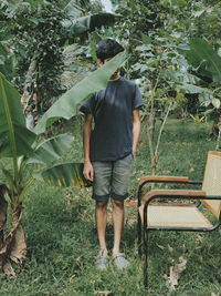 Rear view of man standing by plants
