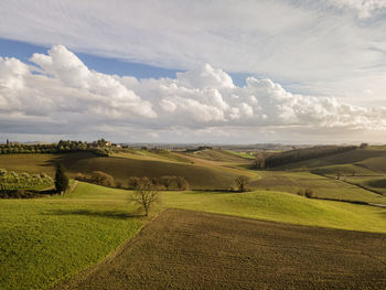 Scenic view of farm against sky