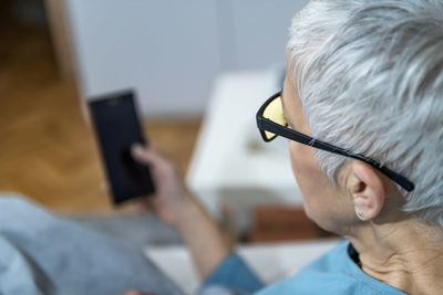 Midsection of man using mobile phone