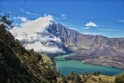 Scenic view of mountain range against cloudy sky