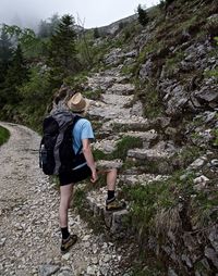 Full length rear view of woman walking on mountain