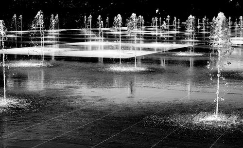 Water fountain in lake during night