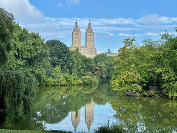 Scenic view of lake against sky in central park, ny,  with a reflection of a building on the water