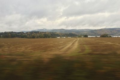 Scenic view of landscape against cloudy sky