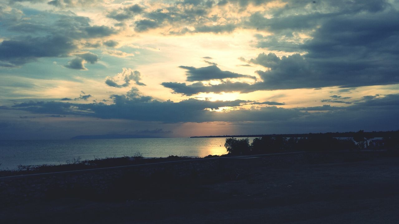 sunset, sky, water, scenics, tranquil scene, sea, cloud - sky, tranquility, beauty in nature, silhouette, horizon over water, cloudy, idyllic, nature, cloud, beach, shore, calm, outdoors, dramatic sky