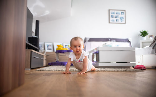 Portrait of boy playing with suitcase at home