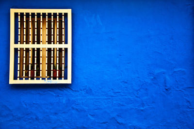 Window on blue wall of house