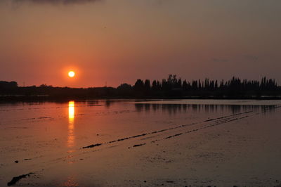 Scenic view of lake against sky during sunset