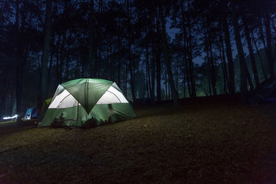 Tent on field against sky at night