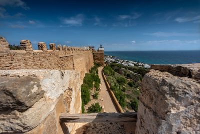 Castle by sea against sky