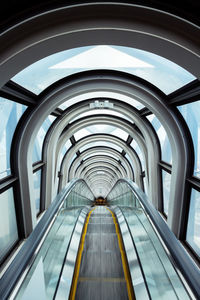 Low angle view of escalator in tunnel