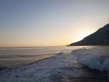 Scenic view of sea against clear sky during sunset