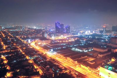 High angle view of illuminated buildings in city at night