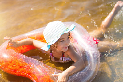 Midsection of boy splashing water