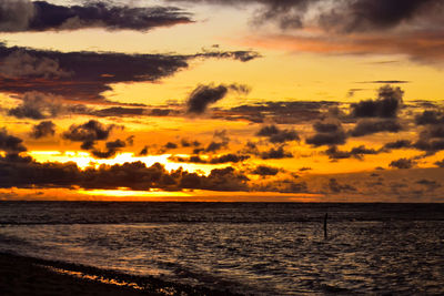 Scenic view of sea against orange sky