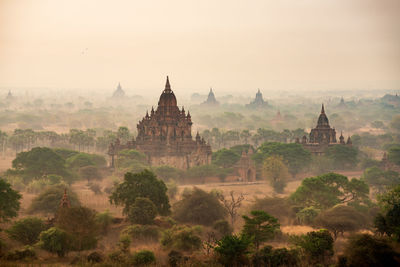Scenic view of temples in mist