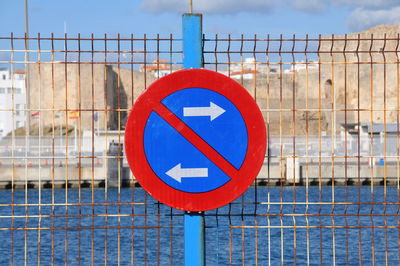 Close-up of road sign against blue sky