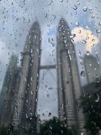 Close-up of wet glass window during rainy season