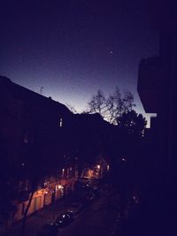 Illuminated buildings against sky at night