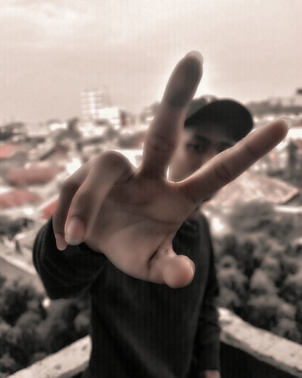 PORTRAIT OF MAN WITH ARMS OUTSTRETCHED AGAINST CITYSCAPE