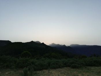 Scenic view of silhouette mountains against clear sky