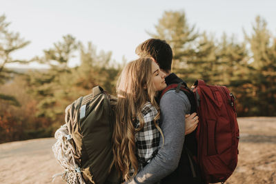 Rear view of couple kissing outdoors