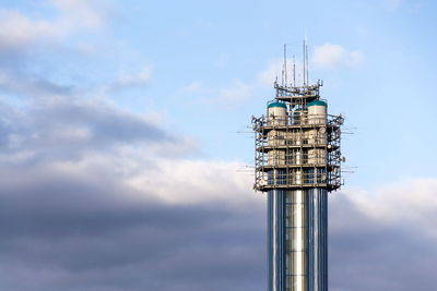 Low angle view of communications tower against sky