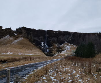 Scenic view of snow covered land against sky