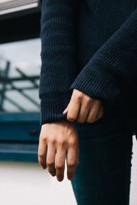 Midsection of woman wearing sweater