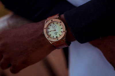 Close-up of hand holding clock