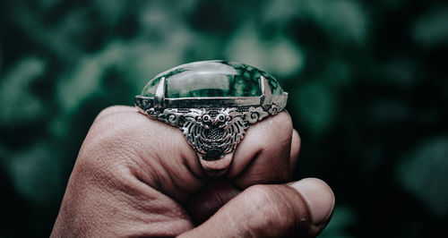 Close-up of hand holding crystal ball