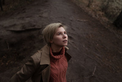 Young woman standing in forest