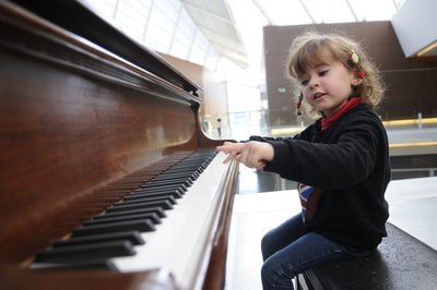 Cute girl playing piano