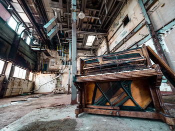 Weathered old piano in abandoned factory