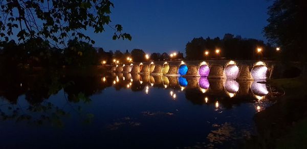 Reflection of trees in water at night