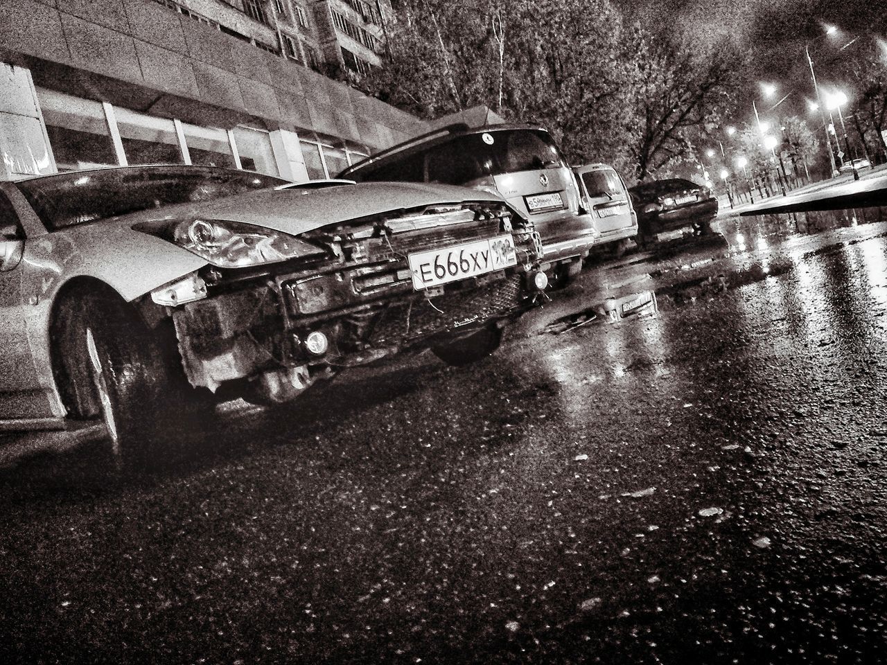 ABANDONED CAR ON ROAD IN RAIN