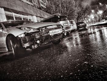 Abandoned car on road in city at night