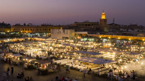 High angle view of people at illuminated djemma el fna square during dusk