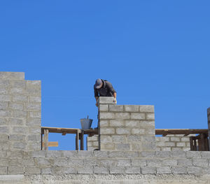 Low angle view of statue against clear blue sky