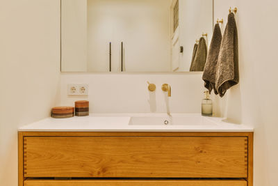 Cropped image of woman washing hands in bathroom